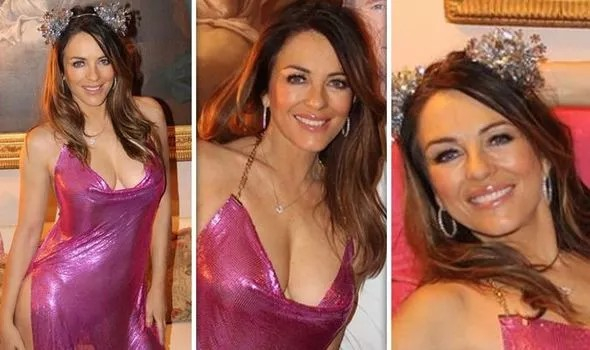 Liz Hurley: Έκοψε ανάσες με το αστραφτερό, σέξι φόρεμά της ποζάροντας δίπλα στο ομοίωμα του Liam Neeson